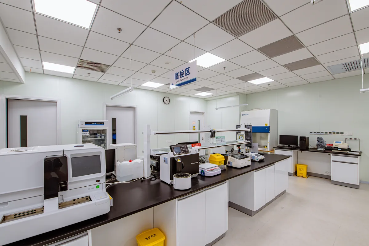 Clinical laboratory with testing equipment arranged on workbenches at Beijing Puhua International Hospital.