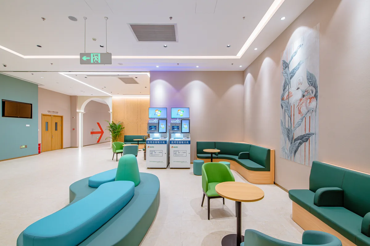 Outpatient waiting area with green seating and small tables at Beijing Puhua International Hospital.